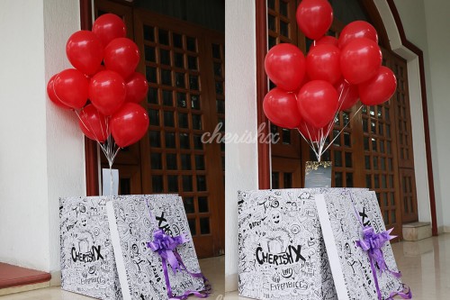 Red Helium Balloons coming out of the Surprise Box.
