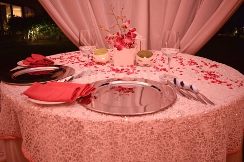 Table Decoration with petals and candles to give a romantic feel to your dinner date.