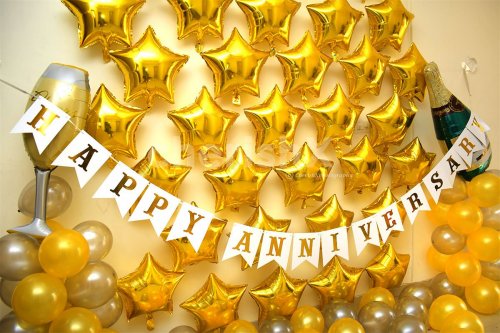 Wall decor with Golden star-shaped foil balloons to add to the Gold Anniversary Decor.