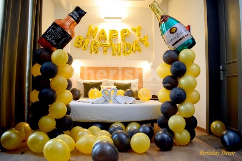 Birthday Champagne Themed Room decoration filled with yellow and black balloons.
