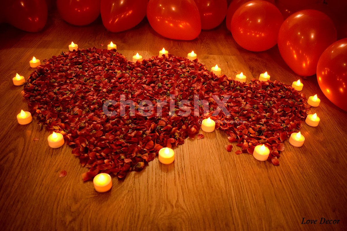 Rose petals decoration on the floor to enhance the overall room decoration.