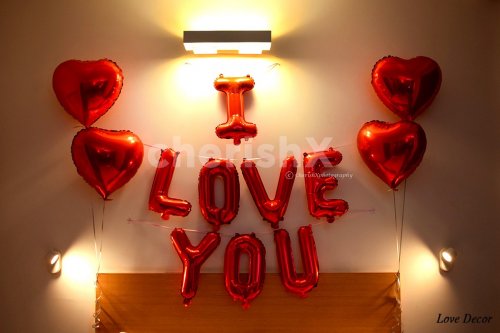 Foil letters "I Love You" Balloon decoration on the wall to enhance the overall love decor.