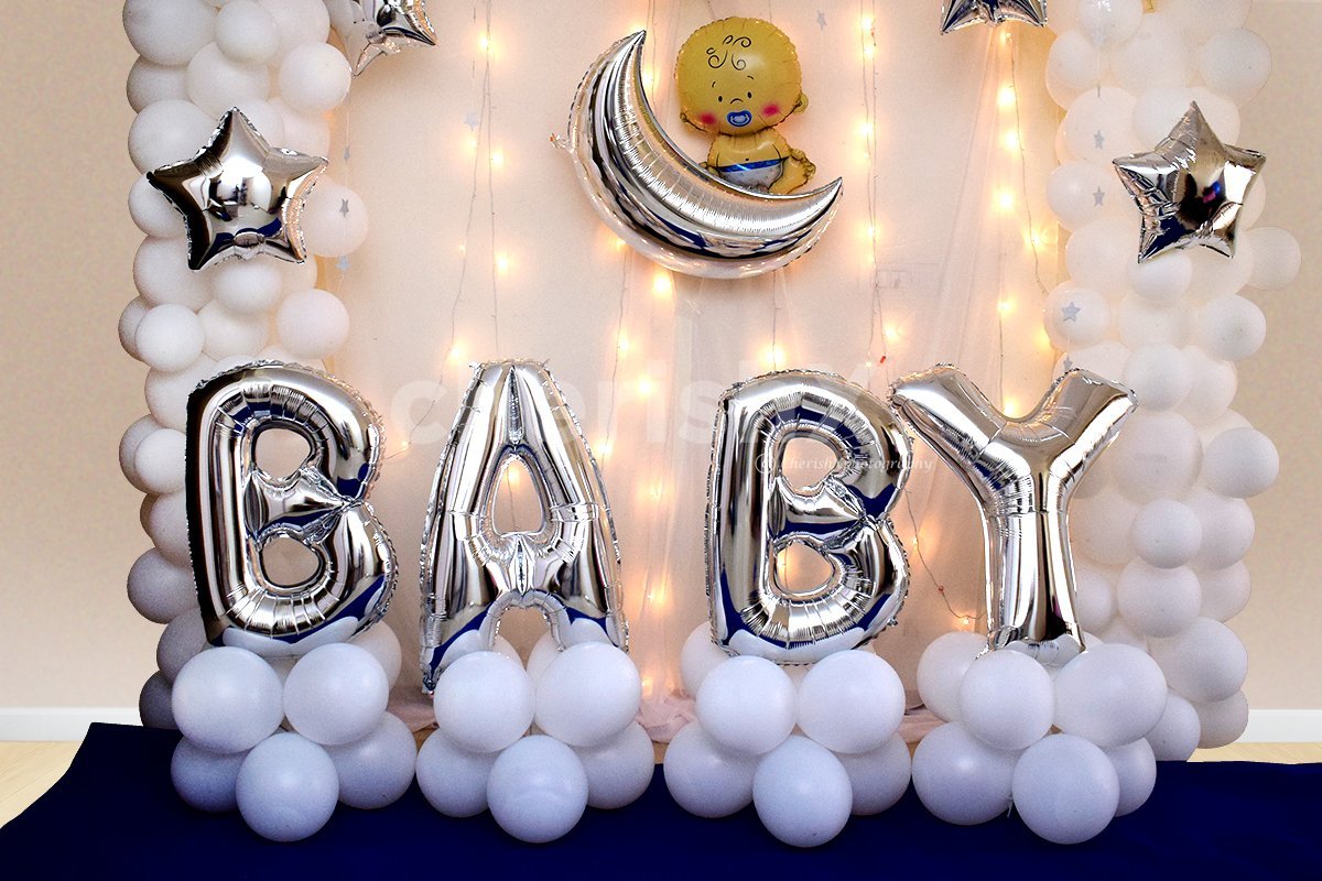 'BABY' silver foil letter balloons attached to bunches of white balloons.
