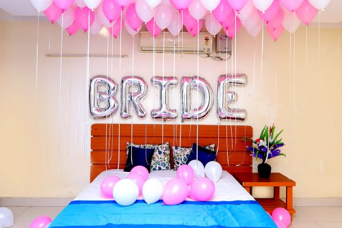 Shades of Pink Coloured Balloons are used for the ceiling and one 'BRIDE' Foil Balloon for the wall.
