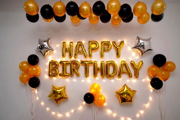 An amazing Golden and Black themed room decor for a Birthday Celebration.