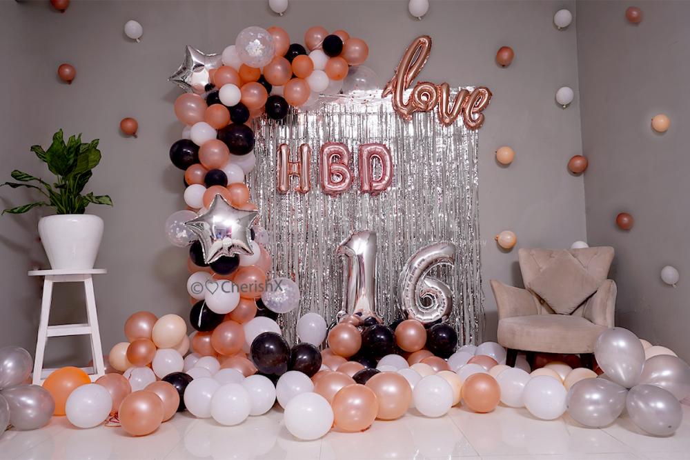 Arc made of Rosegold, Black & White Balloons for a birthday room decoration.