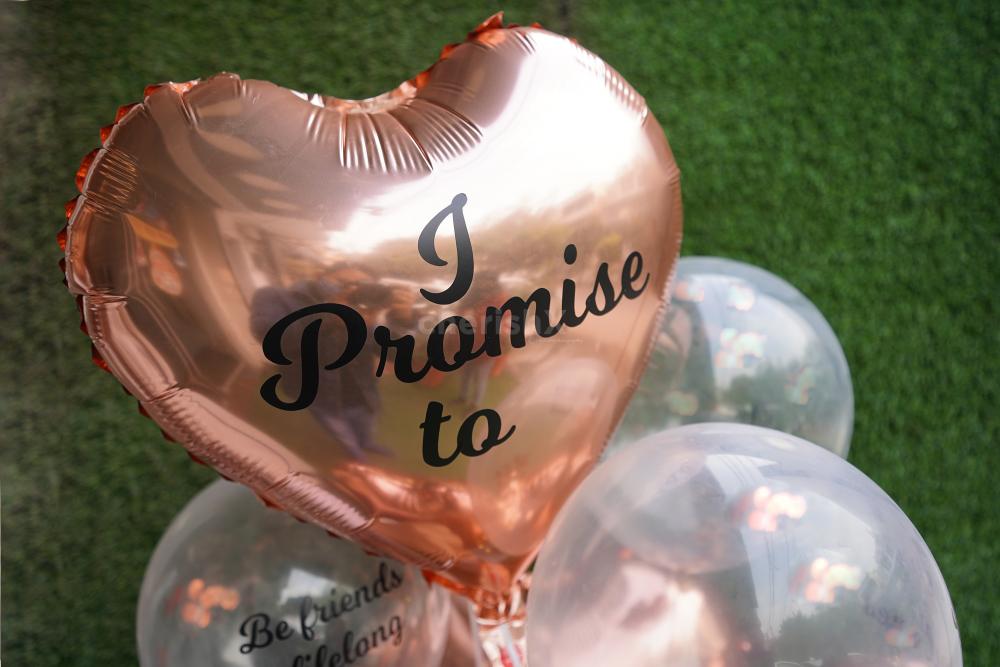 A heart-shaped Rose Gold Balloon saying "I Promise to" indicating to the 7 promises printed on other balloons.