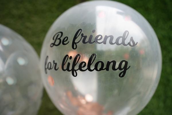 "Be Friends for lifelong" a promise printed on a helium confetti balloon.