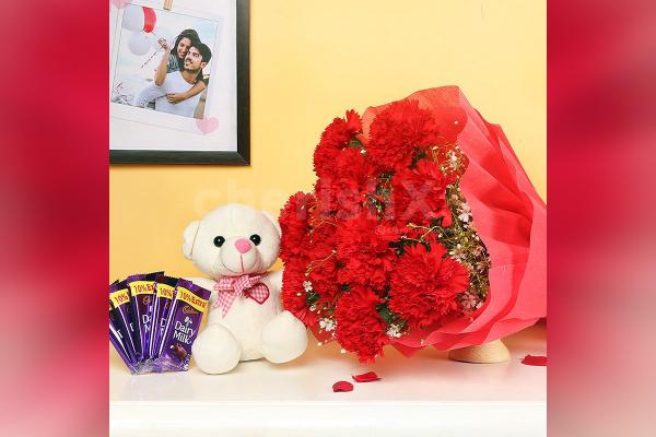 A Combo with 10 red carnations with 5 dairy milk chocolates and a 6' ft cute teddy.