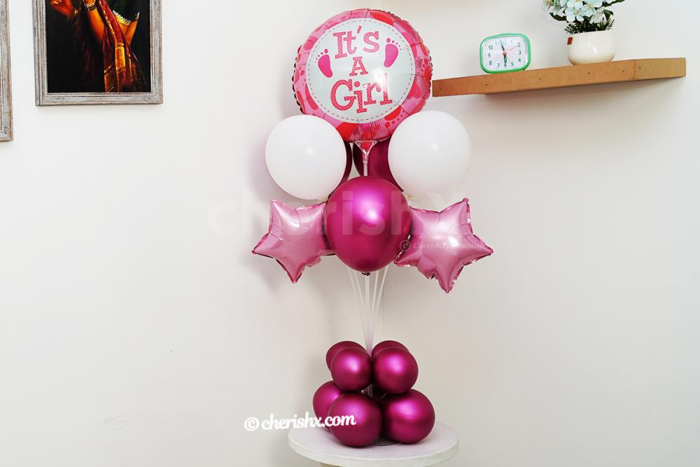 The shades of pink balloons are used for CherishX's It's a girl balloon stand.
