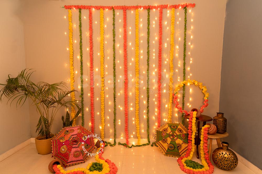 A Festive Umbrella and Flower Garlands Decor curated especially for your Diwali Celebrations!
