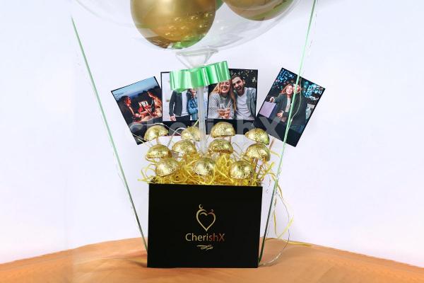 CherishX's Gold & Green Balloon Bucket with Chocolates is designed to bring joy to the face of the recipient!
