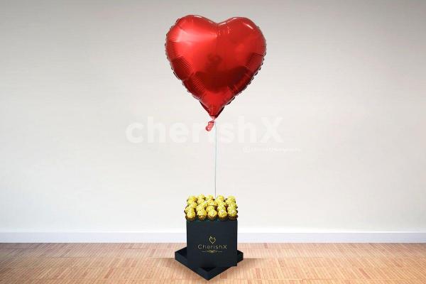 A box of happiness
in the form of chocolates and a heart-shaped balloon.