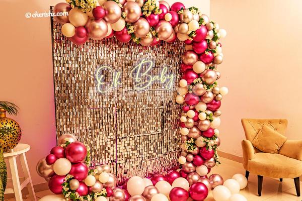 A Baby shower decoration with sequins wall and neon signage by CherishX
