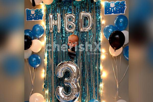 The Boss Baby Surprise Decor consists of 'HBD' Foil balloons as well as a Boss Baby cut-out for the wall.