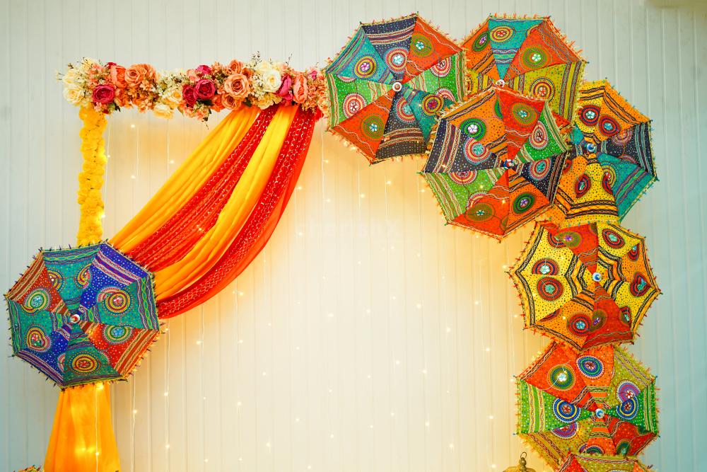 Placing umbrellas on the walls are attractive centrepieces for your mehndi or haldi celebration.