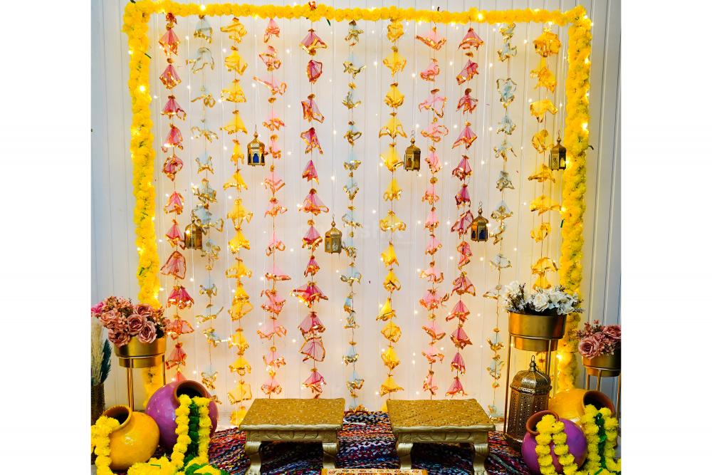 Click endless pictures of the Haldi and Mehndi ceremonies with vibrant and colourful hangings and backdrop decoration
