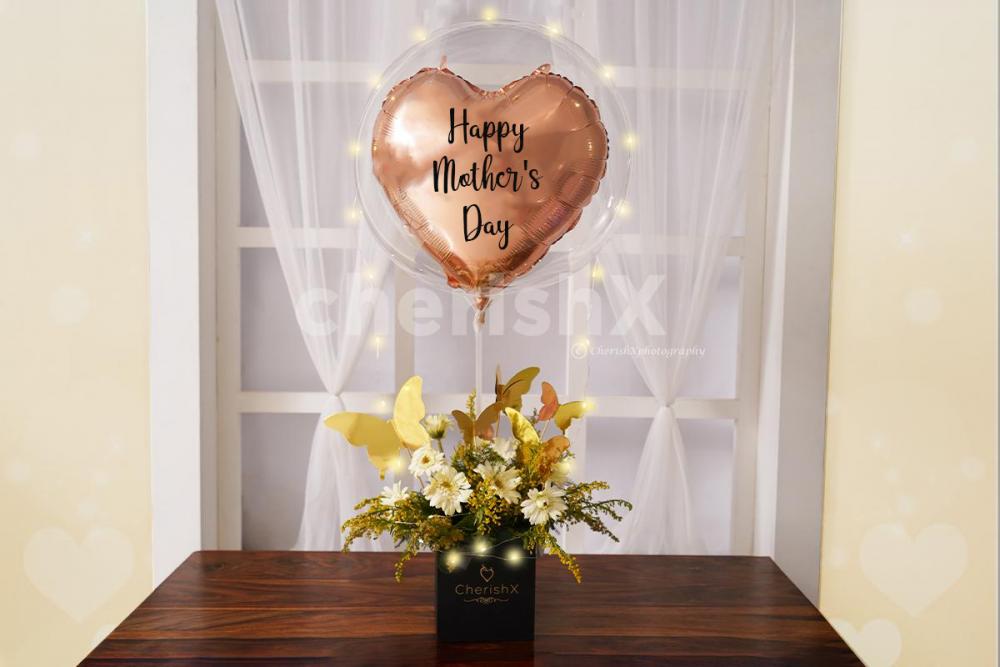 Your mother will love the elegant combination of flowers and balloons