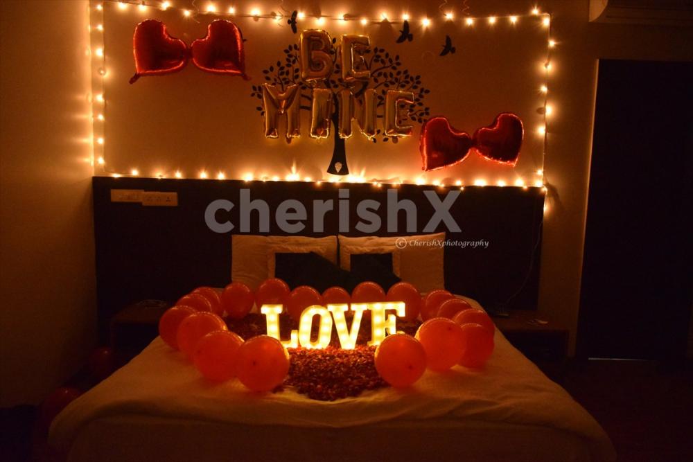 The room decor is specially curated with red balloons and lightings for a romantic feel.