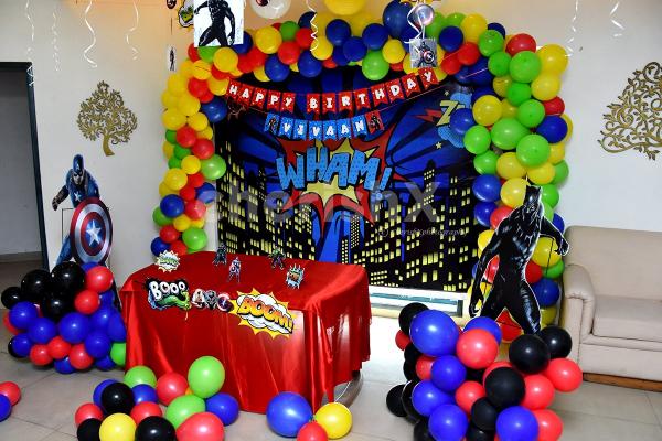 Book this fulfiling decor with balloons and superhero-themed cut-outs.