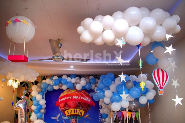 To add to the room decoration, the theme decor consists of Star hangings, Buntings, Paper Air Balloon cut-outs and more.