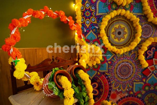 CherishX's Diwali Decoration with 2 pots decorated with 2 yellow Flower Garlands and Green leafs.