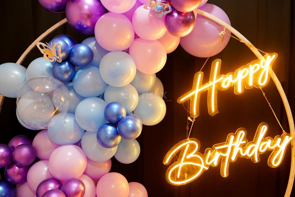 The multi-colored balloon arch is the perfect room and rooftop birthday decoration idea.