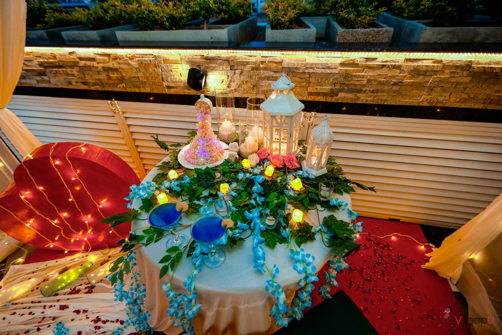 The table is beautifully adorned with a sea of delicate flower petals, creating a stunning visual spectacle.