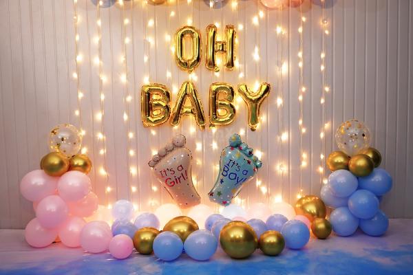 Gold confetti with pastel-coloured balloons makes a wonderful baby shower backdrop.