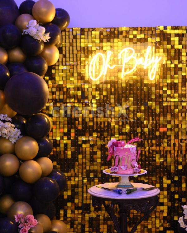 The golden sequin backdrop makes it a glamorous backdrop for your baby shower pictures