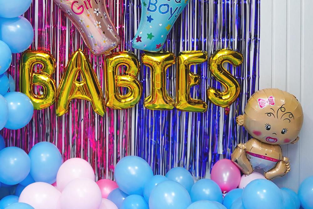 Experience the Delightful Vibe with a balloon backdrop and foil balloons.