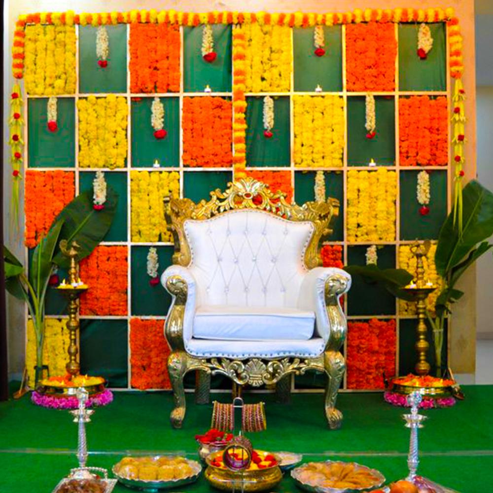 A captivating backdrop adorned with yellow and orange marigold flowers creates a cheerful and lively ambience.