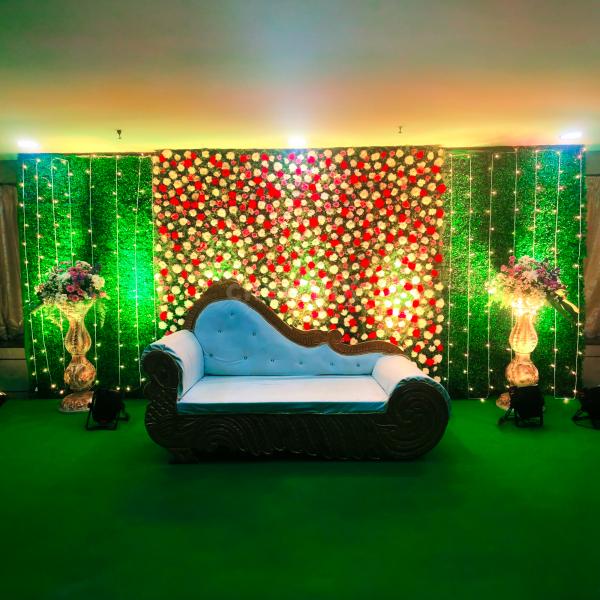 A mesmerizing flower wall backdrop adorned with Carnations, Krisanthmam, and Roses.