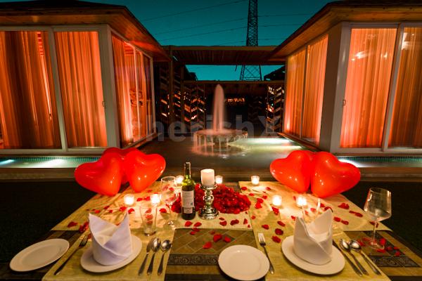 Step into a world of enchantment as you dine by the fountain's edge, surrounded by heart-shaped balloons and the soft glisten of candlelight.