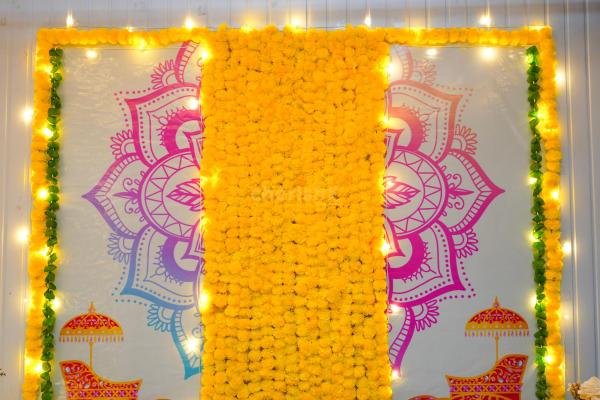 The resplendent backdrop of our Mandala and elephant flex is adorned with radiant garlands.