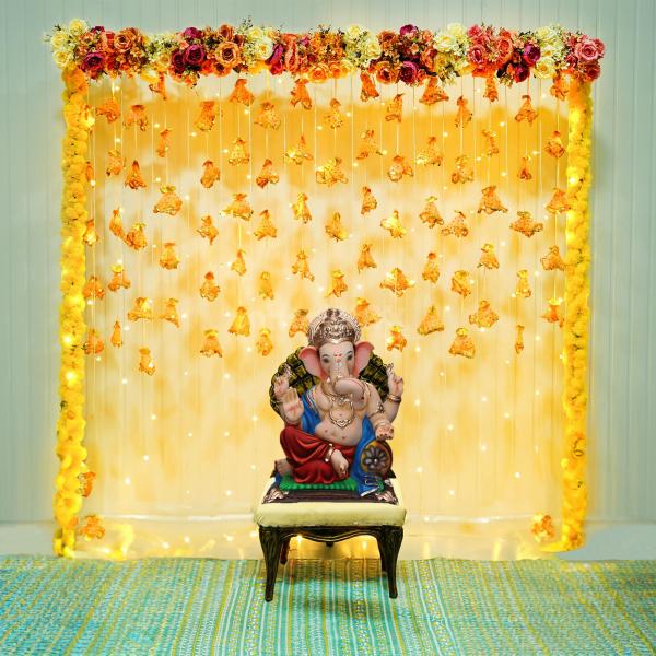 Immerse in divine elegance as your home resonates with the enchanting charm of our Flower and Tassel Ganpati Decorations.