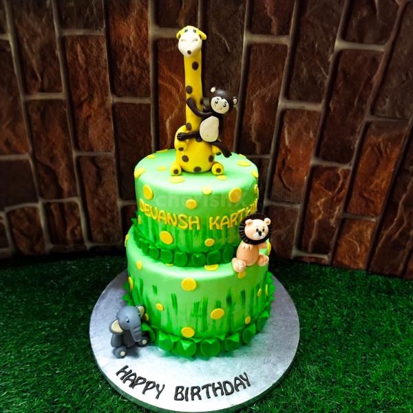 Prepare to be whisked away on an exhilarating jungle adventure with our captivating Giraffe Jungle Theme Two Tier Fondant Cake.