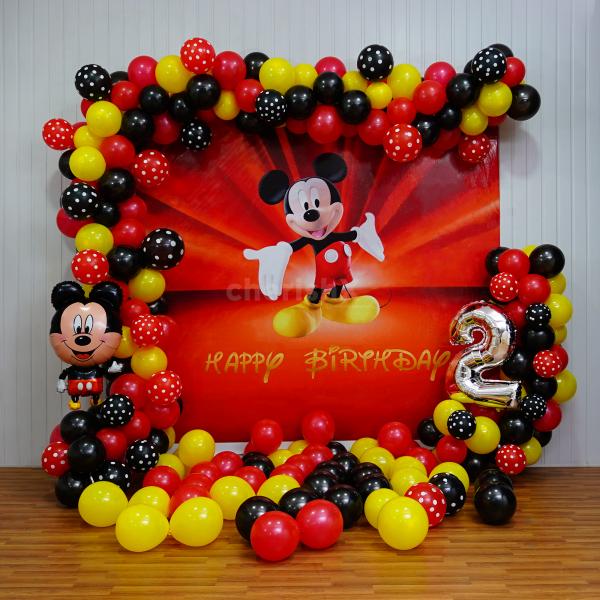 Step into a world filled with their favourite cartoon character, Mickey Mouse, surrounded by a backdrop of colourful balloons and whimsical decor.