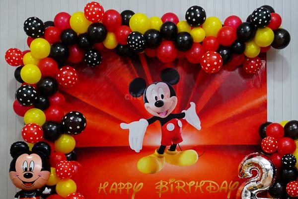Picture-perfect setting with Mickey Mouse foil balloon and silver digit foil balloon.
