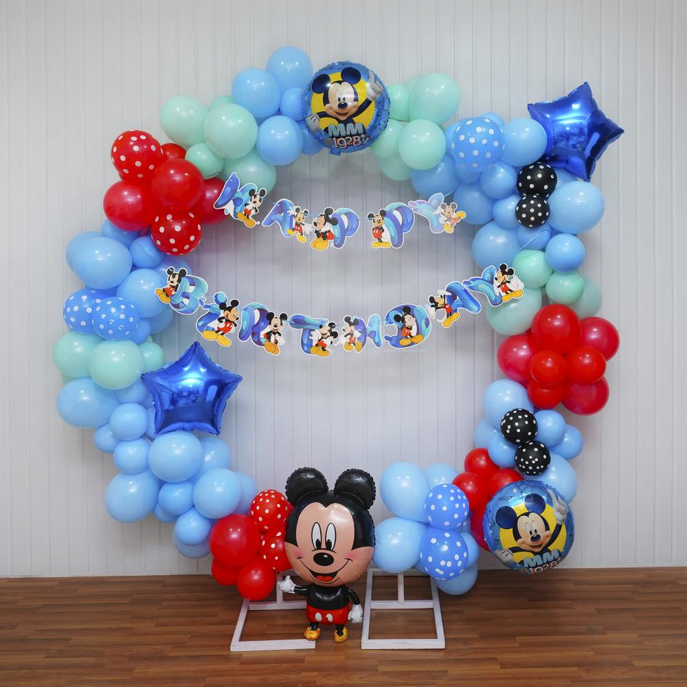 From the iconic Happy Birthday Mickey bunting to the enchanting mix of balloons in pastel blue, green, and red, every detail celebrates the timeless charm of Disney.