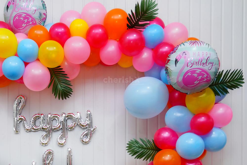Let the Birthday Shine with a Silver Cursive Foil Balloon Amidst the Flamingo-Themed Decor.