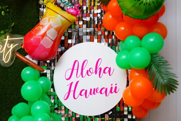 Elevate the Celebration with a Vibrant Balloon Arch in Hawaiian Hues.