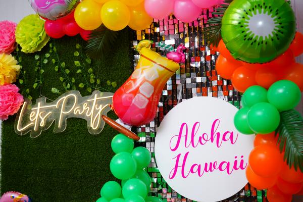 Craft an Authentic Hawaiian Experience with Pom-Pom Accents and Neon Lights.