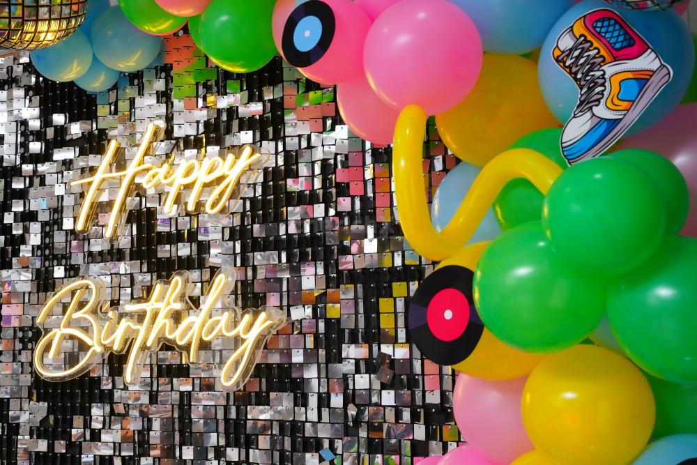 A symphony of silver sequins, vibrant balloons, and vintage accents, set the stage for a birthday experience like no other.