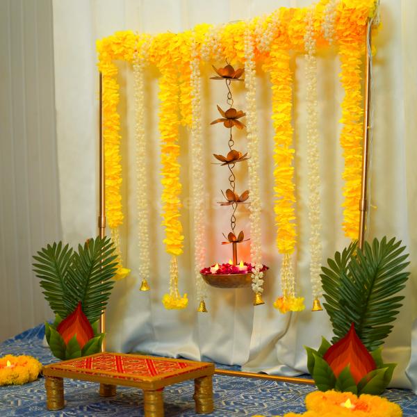 Our all-inclusive kit boasts a rectangular stand, vibrant yellow garlands and tassels, fragrant jasmine flower strings, and more.
