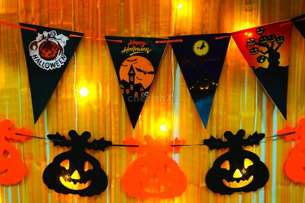 Embrace Halloween with Pumpkin Bunting and Ghost Paper Cutouts.