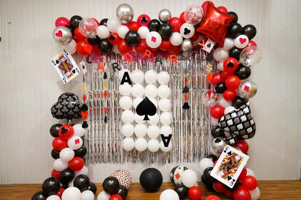 Elegant Casino-Themed Balloon Arch in Black, Red, and White Balloons.
