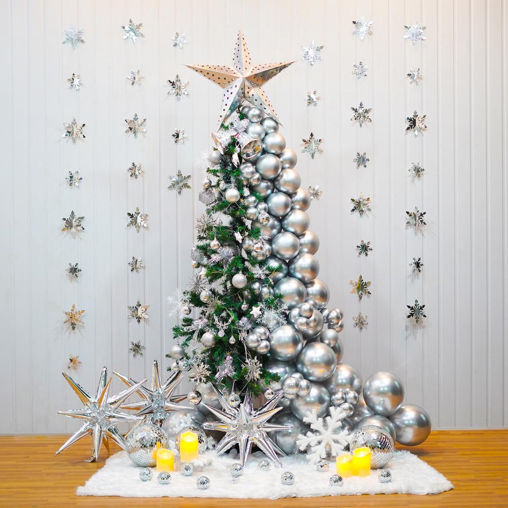 A beautiful Christmas tree decoration features a 6-ft non-pine tree decked out with silver chrome balloons, LED lights, and a silver paper star.