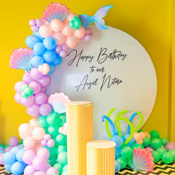 A whimsical birthday setup featuring a ring backdrop.