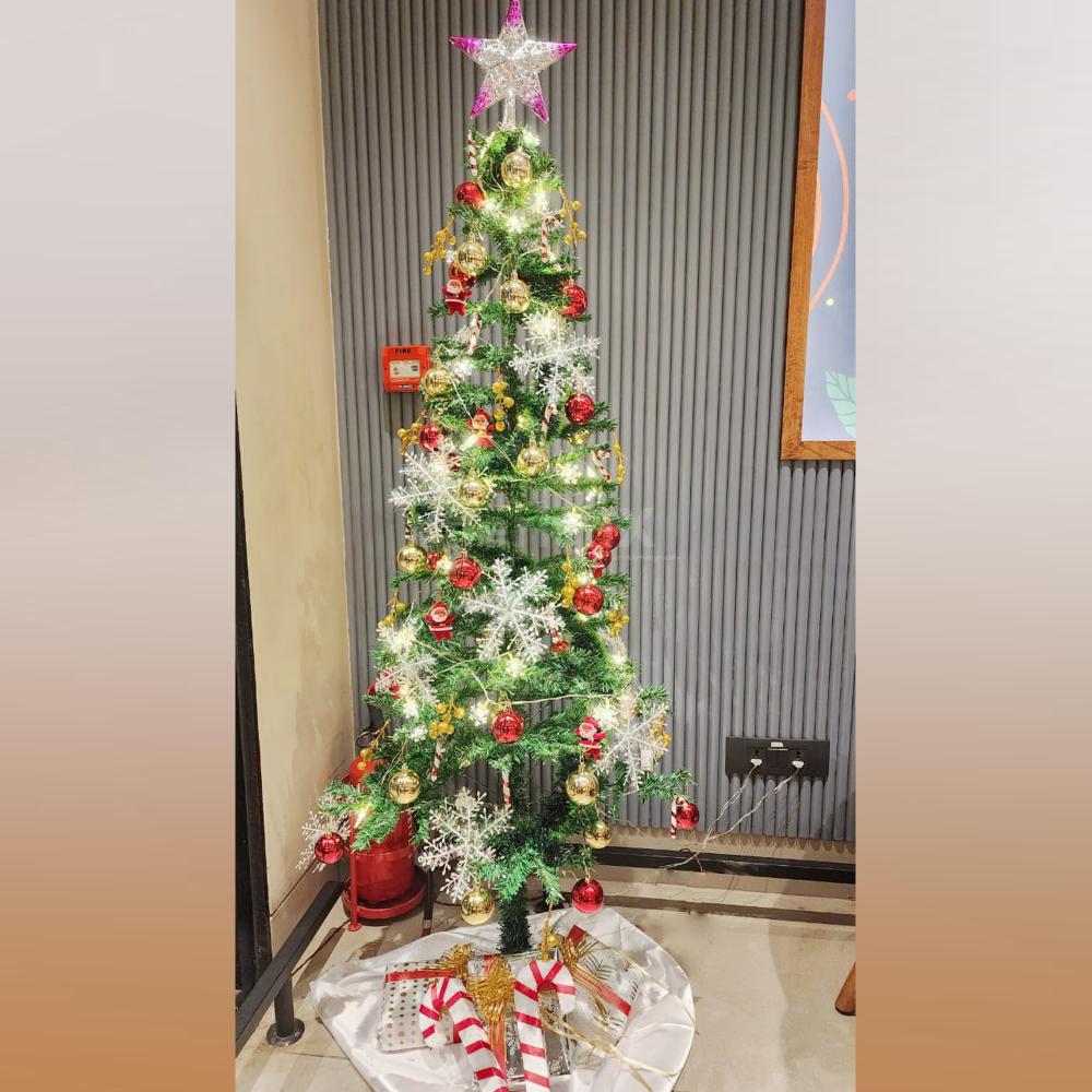 A 6-ft tree surrounded by delightful ornaments, candy sticks, and gift boxes.
